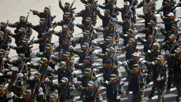 Newly-recruited Iraqi army volunteers take part in a military parade in the shrine city of Najaf, in central Iraq