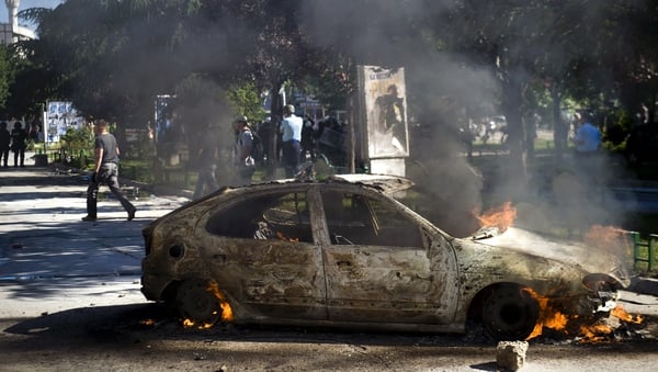 A vehicle burns during clashes between riot-police and protesters in the divided town of Mitrovica