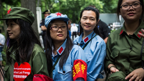 Chinese girls in uniforms at homeless lunch