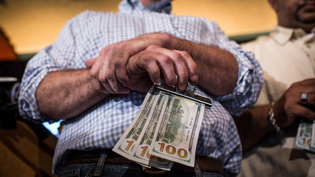 Man holds money at homeless lunch