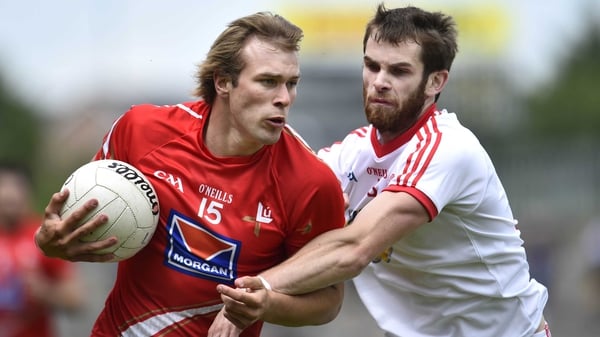 Tyrone's Ronan McNamee (r) and Louth's Conor Grimes