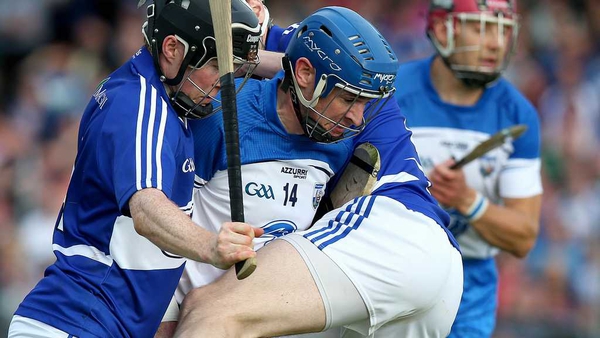 Shane Walsh is tackled by two Laois players