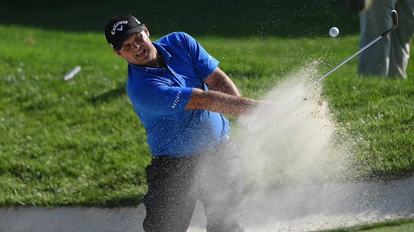 Patrick Reed hits out of a bunker on the 17th hole during the third round of the Quicken Loans National