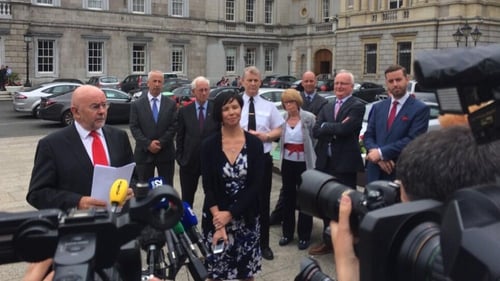 Ruairi Quinn made the announcement outside Leinster House at midday