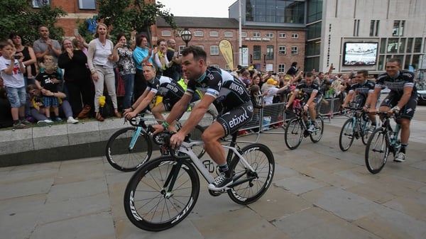 Mark Cavendish and his team-mates are greeted by supporters as they ride through Millennium Square in Leeds ahead of the start of the Tour