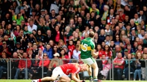 Kerry's James O'Donoghue celebrates a score at Páirc Úi Chaoimh as Michael Shields of Cork lies crestfallen