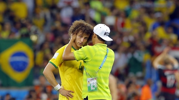 David Luiz is consoled by Brazil's suspended captain Thiago Silva after the 7-1 thumping by Germany