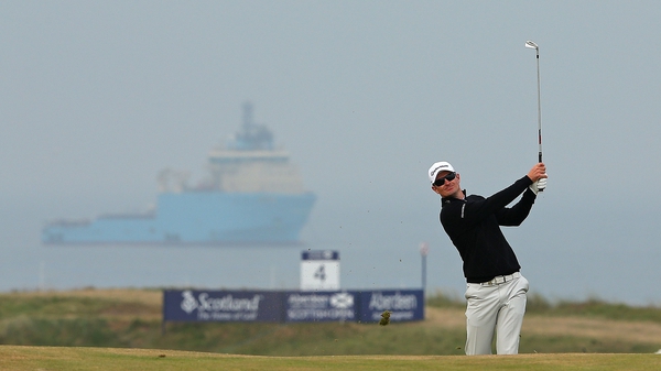 Justin Rose of England hits his approach shot on the 16th hole