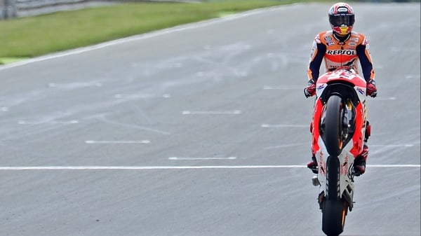 Marc Marquez pulls a wheelie to celebrate victory