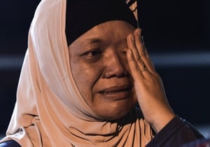 A relative of a crew member in tears in Kuala Lumpur, Malaysia