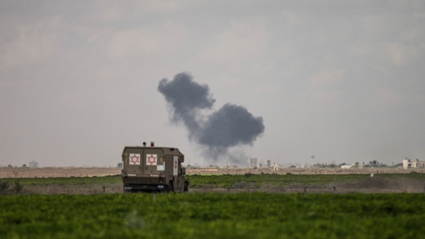 An Israeli airstrike sends up a plume of smoke in Gaza as seen from near Sderot, Israel