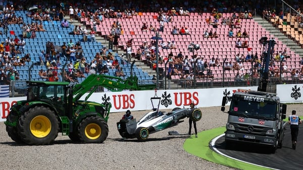 Lewis Hamilton's Mercedes is removed from the track following his early crash