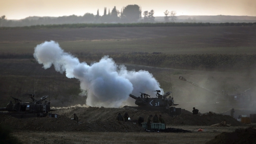 Israeli soldiers fire towards Gaza from their position near Israel's border