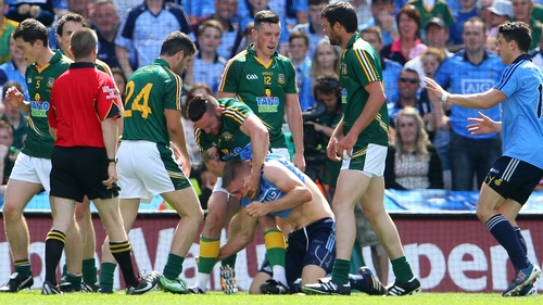 Meath's Mickey Burke tussles with Eoghan O'Gara
