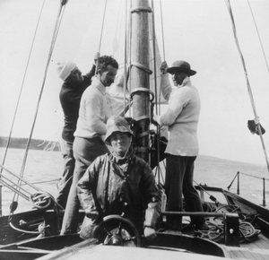 Molly Childers on board the Asgard with Erskine Childers (centre) in 1910