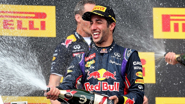 Daniel Ricciardo celebrates victory on the podium