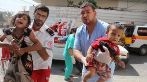 Injured children are carried into Al Najar hospital after Israeli air strikes in Rafah