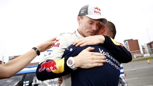 Jari-Matti Latvala hugs a member of his team as he celebrates victory
