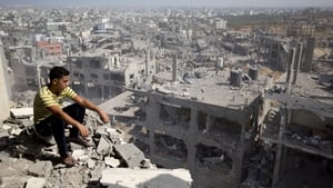 A boy surveys the damage from the Israeli military campaign in Gaza City