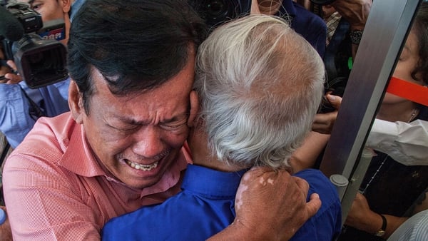 Two survivors cry after hearing the guilty verdict