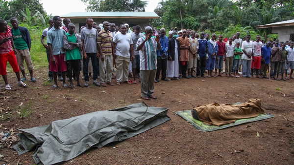 Liberian Muslims pray before burying the bodies of Ebola victims