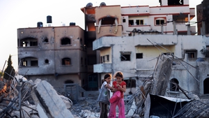 Children look at some of the belonging they salvaged from their destroyed homes in Jabalia, northern Gaza