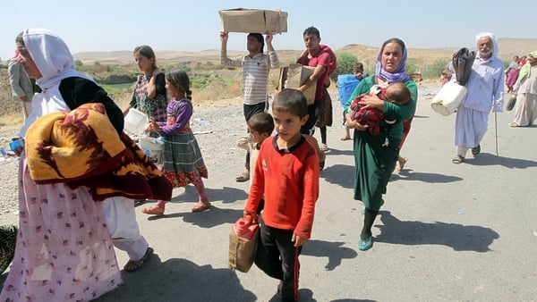 Displaced Iraqis from the Yazidi community cross the Iraqi-Syrian border at the Fishkhabur crossing