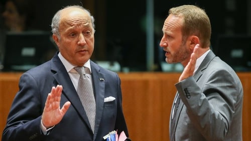 French foreign minister Laurent Fabius (L) chats with his Danish counterpart Martin Lidegaard at the EU meeting