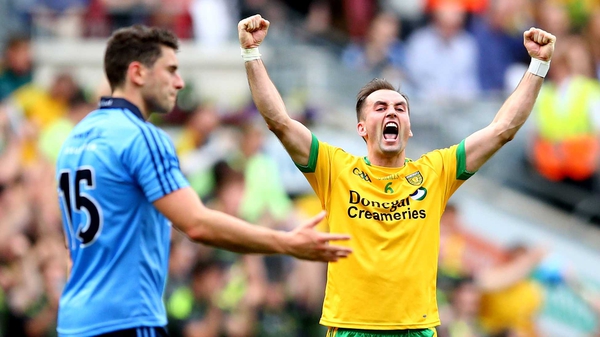 Donegal's Karl Lacey celebrates at the final whistle, while Bernard Brogan looks on, dejected