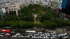 Traffic builds up in front of a small park in downtown Daegu in South Korea