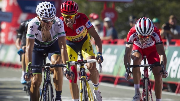 Alberto Contador (c) retains the lead after finishing third