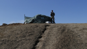 Ukrainian soldiers guard a check point near Mariupol