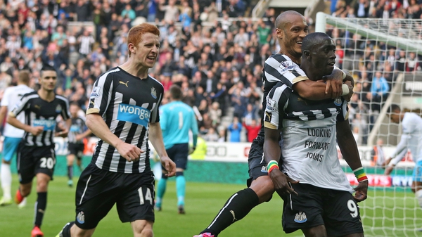 Newcastle United's Senegalese striker Papiss Cisse (right) celebrates after scoring his second goal