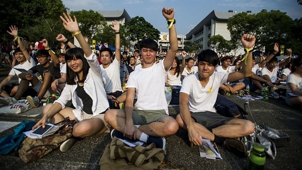 Dressed in white and wearing yellow ribbons, students from more than 20 universities and colleges gathered at a Chinese University