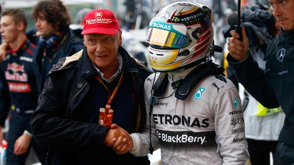 Former three-time champion Niki Lauda congratulates Lewis Hamilton in the pit lane