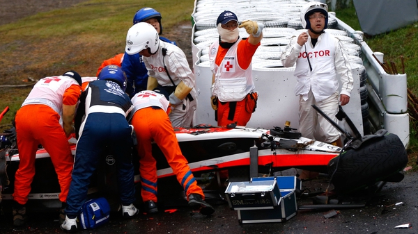 Medics attend Bianchi after he crashed during the Japanese Grand Prix