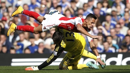 Arsenal's Alexis Sanchez collides with Chelsea's Thibaut Courtois. Courtois was substituted 13 minutes later