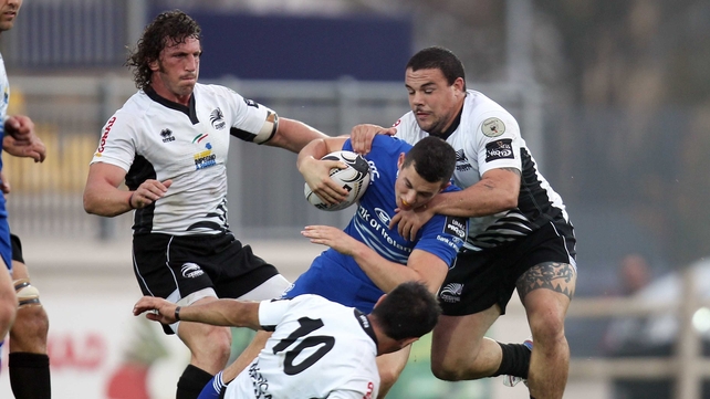 Noel Reid is wrapped up by the Zebre defence