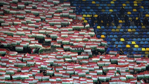 Hungarian fans hold up their national flag prior to the match against Romania