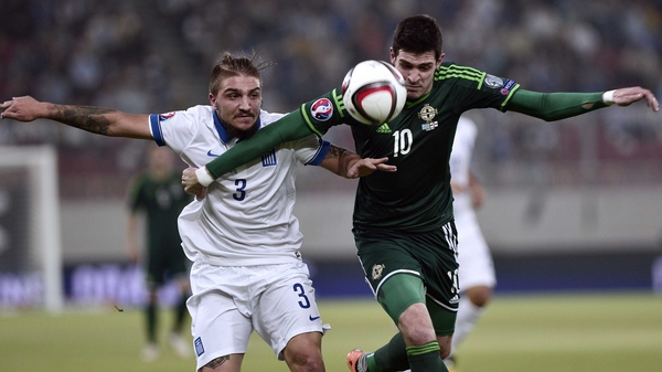 Northern Ireland's Kyle Lafferty (right) vies for the ball with Greece's Kostas Stafylidis