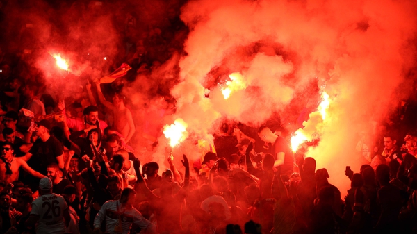 Galatasaray AS fans light flares after conceding a second goal during their side's Champions League match against Arsenal