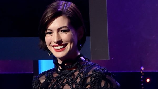 Anne Hathaway happily posed for a bikini clad picture after being snapped by the paparazzi
