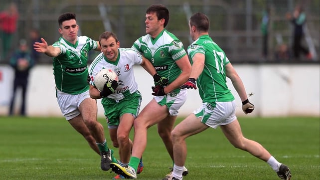Michael Browne of Sarsfields finds himself outnumbered