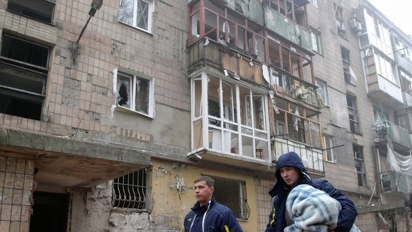 Locals walk through the streets of Donetsk, which has seen heavy shelling this weekend