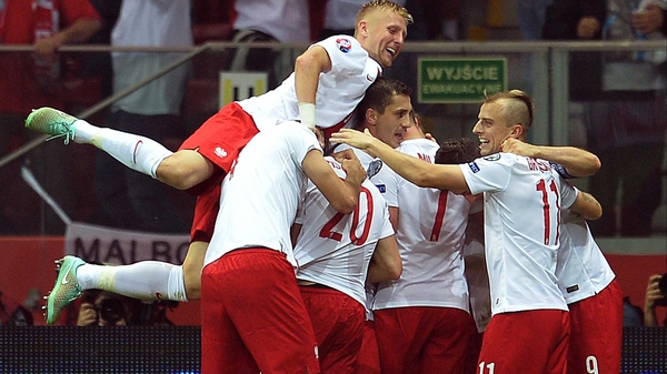 Poland's players celebrate Arkadiusz Milik's opener against Germany in Warsaw