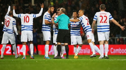 QPR players protest to referee Mike Dean as Charlie Austin's goal is disallowed during the match between Queens Park Rangers and Manchester City