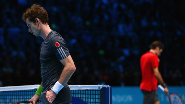 Andy Murray looks on in the round robin singles match against Roger Federer