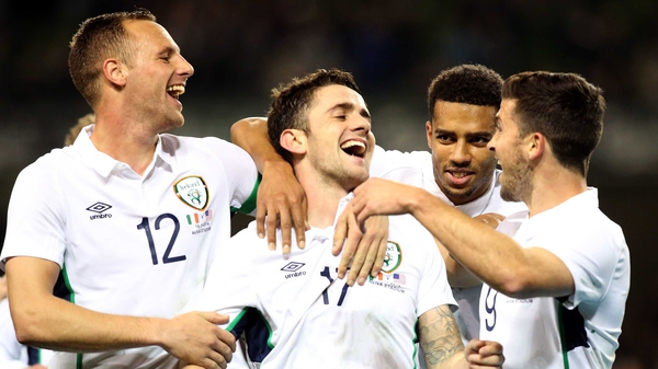 Robbie Brady (C) gets the congratulations after scoring Ireland's fourth goal against the USA