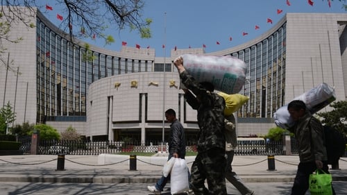 China central bank says economic growth could slow to 7.1% in 2015 from an expected 7.4% this year