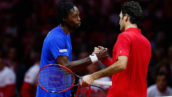 Gael Monfils (L) is congratulated by Roger Federer